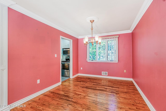 18 Croman Ct, Hazlet, NJ 07730 - unfurnished dining area featuring a chandelier, wood finished floors, and ornamental molding