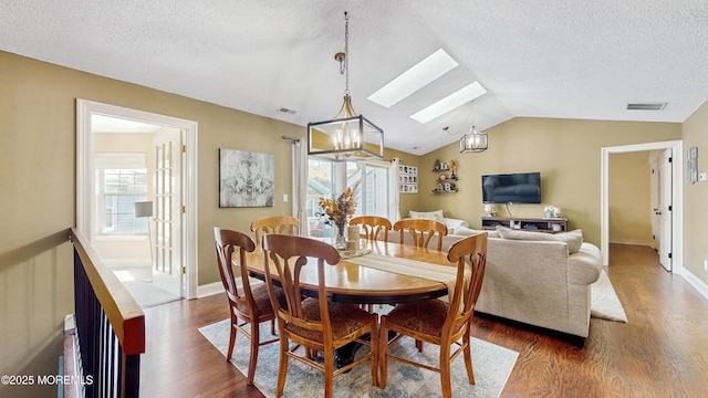 280 Tulip Ln, Freehold, NJ 07728 - dining area with a skylight, dark wood-type flooring, lofted ceiling, a textured ceiling, and baseboards