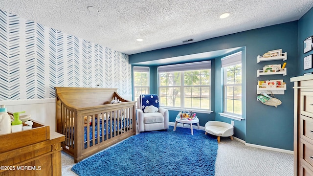 280 Tulip Ln, Freehold, NJ 07728 - bedroom with carpet flooring, a textured ceiling, multiple windows, a crib, and wallpapered walls