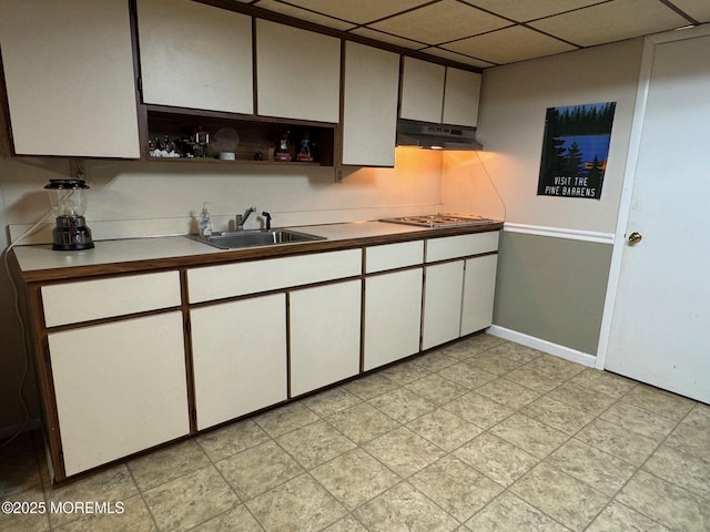 7 Rosewood Dr, Milltown, NJ 08850 - kitchen with under cabinet range hood, a sink, stainless steel gas cooktop, baseboards, and open shelves