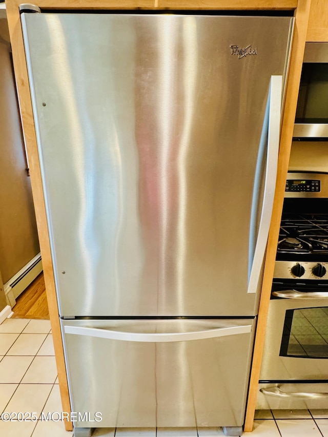 7 Rosewood Dr, Milltown, NJ 08850 - kitchen view of stainless steel appliances, a baseboard heating unit, and baseboards