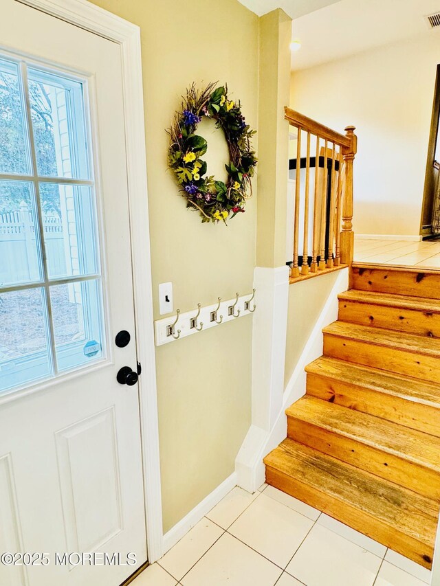 7 Rosewood Dr, Milltown, NJ 08850 - doorway with tile patterned flooring, stairway, and baseboards
