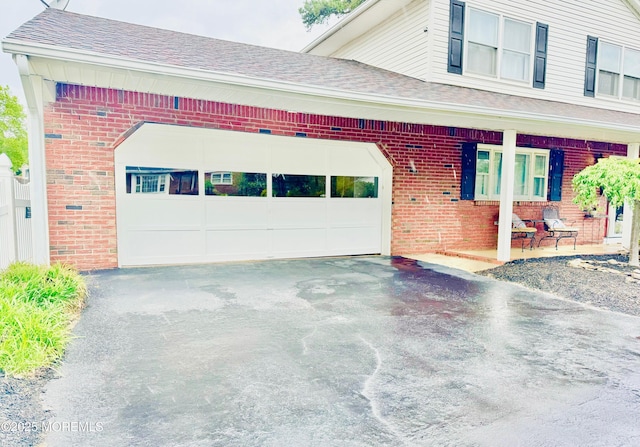 7 Rosewood Dr, Milltown, NJ 08850 - view of front of property featuring brick siding, asphalt driveway, and an attached garage