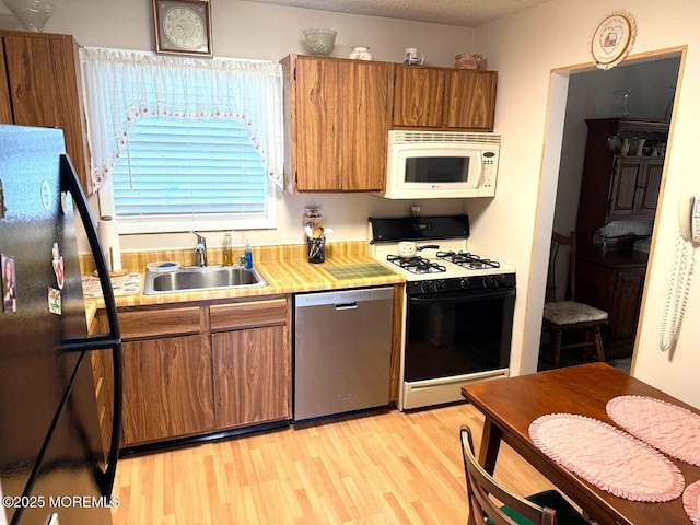132 Seaview Ave, Brick, NJ 08723 - kitchen featuring dishwasher, freestanding refrigerator, gas range oven, white microwave, and a sink