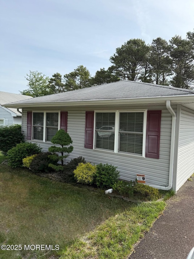 132 Seaview Ave, Brick, NJ 08723 - view of front facade with a front lawn and roof with shingles