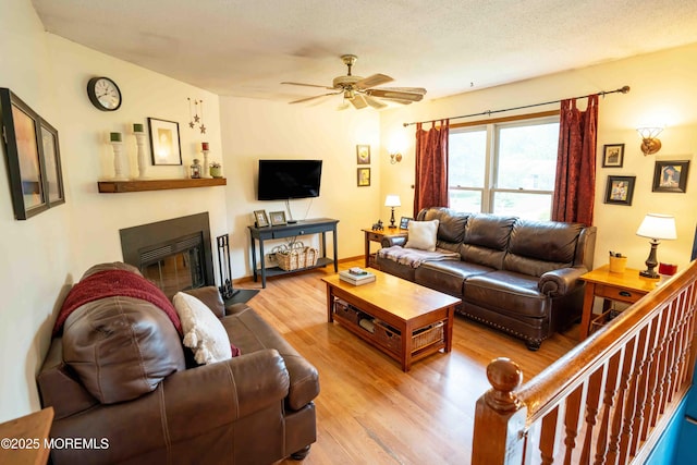817 Wright Debow Rd, Jackson, NJ 08527 - living area with wood finished floors, a ceiling fan, and a fireplace with flush hearth