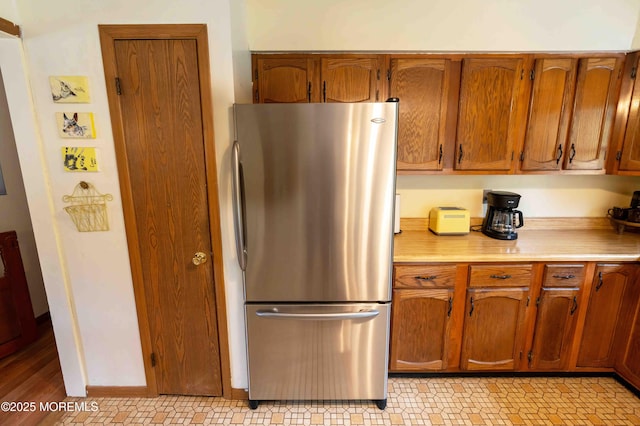 817 Wright Debow Rd, Jackson, NJ 08527 - kitchen with freestanding refrigerator, light countertops, and brown cabinetry