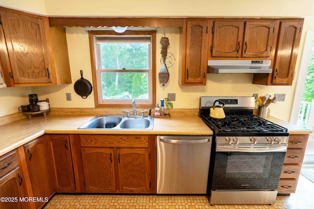 817 Wright Debow Rd, Jackson, NJ 08527 - kitchen with stainless steel appliances, under cabinet range hood, a sink, light countertops, and brown cabinetry