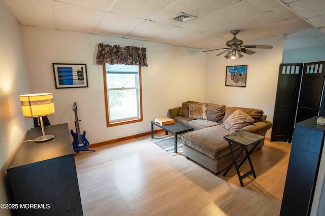 817 Wright Debow Rd, Jackson, NJ 08527 - living area with light wood-type flooring, a ceiling fan, a paneled ceiling, and baseboards