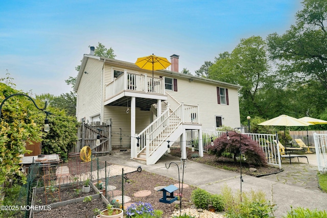 817 Wright Debow Rd, Jackson, NJ 08527 - rear view of property featuring a vegetable garden, stairs, a fenced backyard, a chimney, and a patio