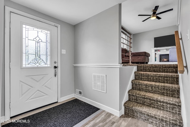 120 Lake Winnepesaukee Dr, Little Egg Harbor, NJ 08087 - entrance foyer with wood finished floors, plenty of natural light, a glass covered fireplace, and baseboards
