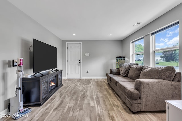 120 Lake Winnepesaukee Dr, Little Egg Harbor, NJ 08087 - living room with light wood-type flooring, recessed lighting, baseboards, and a glass covered fireplace
