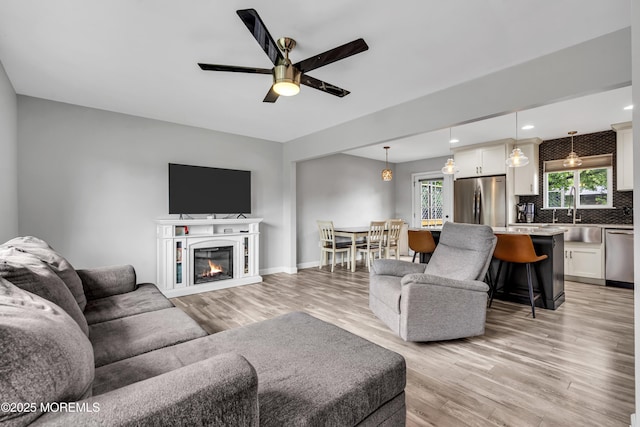120 Lake Winnepesaukee Dr, Little Egg Harbor, NJ 08087 - living room with light wood-style floors, ceiling fan, recessed lighting, a glass covered fireplace, and baseboards