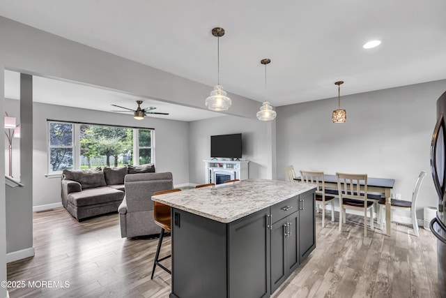 120 Lake Winnepesaukee Dr, Little Egg Harbor, NJ 08087 - kitchen featuring light wood-style flooring, baseboards, a kitchen island, decorative light fixtures, and ceiling fan