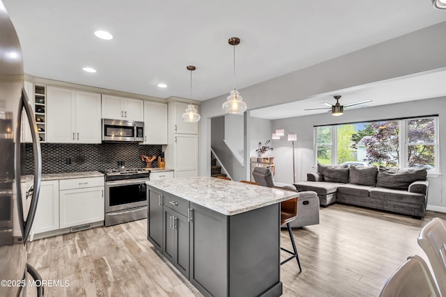 120 Lake Winnepesaukee Dr, Little Egg Harbor, NJ 08087 - kitchen with stainless steel appliances, white cabinetry, open shelves, a center island, and light wood-type flooring