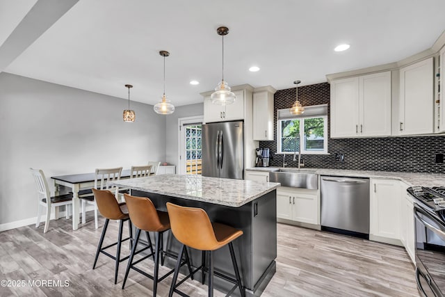 120 Lake Winnepesaukee Dr, Little Egg Harbor, NJ 08087 - kitchen with stainless steel appliances, a sink, backsplash, a center island, and light wood-type flooring