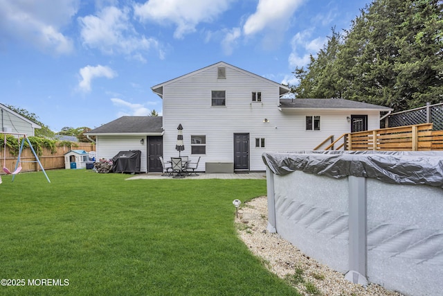 120 Lake Winnepesaukee Dr, Little Egg Harbor, NJ 08087 - rear view of house featuring a playground, a patio area, a covered pool, and a shingled roof