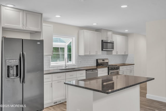 352 Leesville Rd, Jackson, NJ 08527 - kitchen featuring appliances with stainless steel finishes, a sink, light wood-style floors, white cabinetry, and recessed lighting