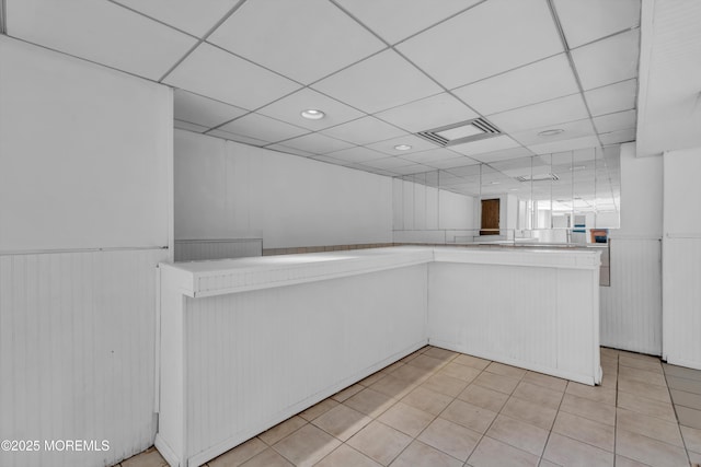 352 Leesville Rd, Jackson, NJ 08527 - kitchen with light countertops, a wainscoted wall, recessed lighting, light tile patterned flooring, and a paneled ceiling