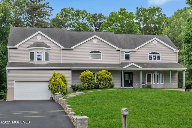 352 Leesville Rd, Jackson, NJ 08527 - view of front facade with a garage, asphalt driveway, a front yard, and covered porch