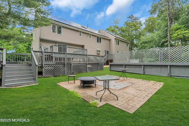 352 Leesville Rd, Jackson, NJ 08527 - back of property featuring a patio area, roof mounted solar panels, an outdoor fire pit, stairs, and a wooden deck