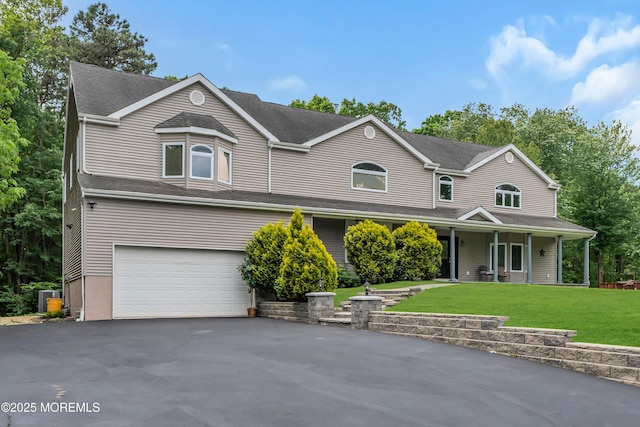 352 Leesville Rd, Jackson, NJ 08527 - view of front of house with a garage, driveway, a front lawn, a porch, and cooling unit
