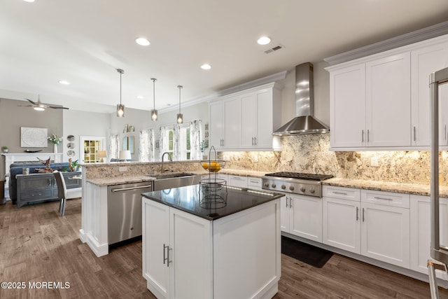 2 Haley Cir, Barnegat, NJ 08005 - kitchen with appliances with stainless steel finishes, wall chimney exhaust hood, a sink, a peninsula, and white cabinetry