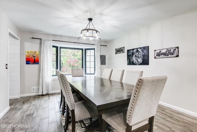 25 Merritt Ter, Matawan, NJ 07747 - dining room featuring wood finished floors, a chandelier, and baseboards