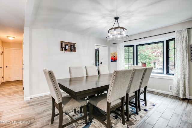 25 Merritt Ter, Matawan, NJ 07747 - dining room featuring baseboards, light wood-style flooring, and a chandelier