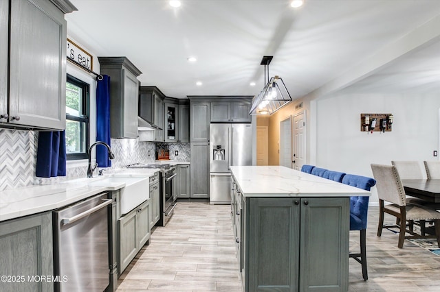 25 Merritt Ter, Matawan, NJ 07747 - kitchen featuring premium appliances, a kitchen island, a kitchen breakfast bar, tasteful backsplash, and recessed lighting
