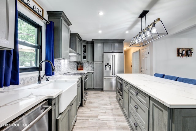 25 Merritt Ter, Matawan, NJ 07747 - kitchen with high end appliances, a center island, decorative backsplash, light stone countertops, and recessed lighting