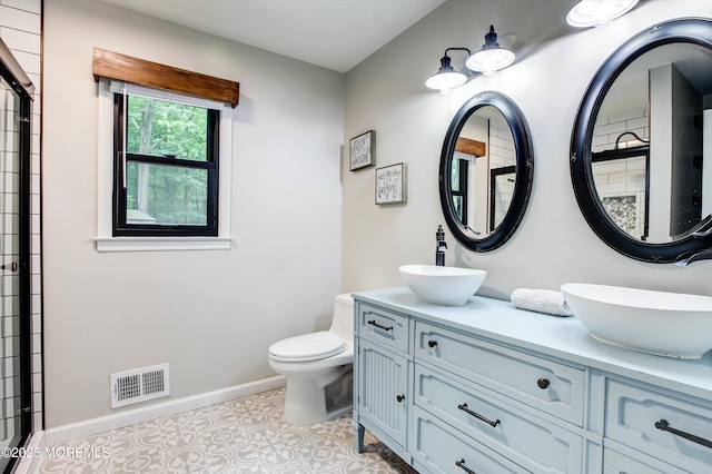 25 Merritt Ter, Matawan, NJ 07747 - bathroom featuring toilet, double vanity, baseboards, and a shower