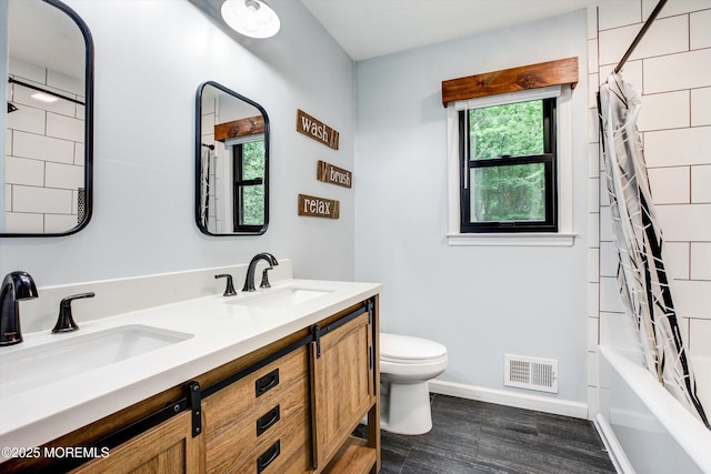 25 Merritt Ter, Matawan, NJ 07747 - full bathroom with toilet, double vanity, wood finished floors, baseboards, and shower / bath combo with shower curtain