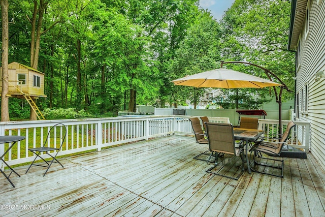 25 Merritt Ter, Matawan, NJ 07747 - wooden terrace featuring outdoor dining space, a swimming pool, a fenced backyard, and view of wooded area