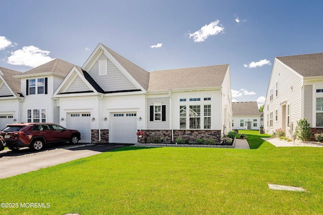 21 Gulfstream Rd, New Egypt, NJ 08533 - view of front of house with driveway, a front yard, stone siding, and a garage