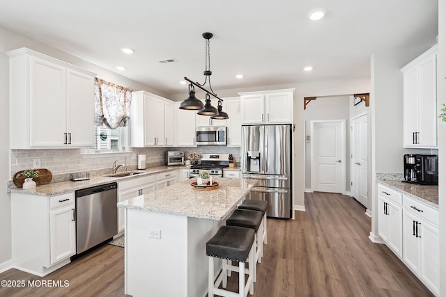 21 Gulfstream Rd, New Egypt, NJ 08533 - kitchen with stainless steel appliances, a sink, wood finished floors, white cabinets, and recessed lighting