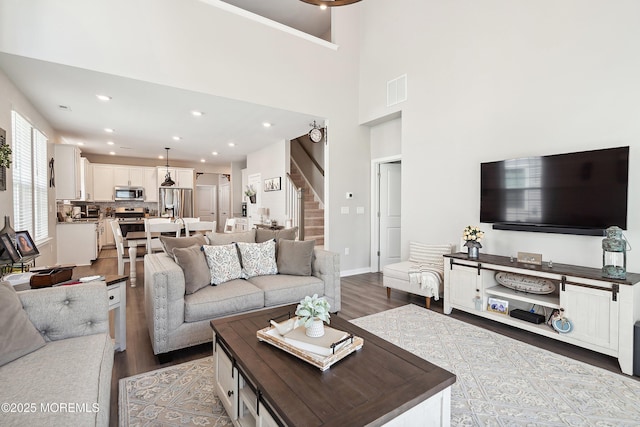 21 Gulfstream Rd, New Egypt, NJ 08533 - living area featuring dark wood finished floors, stairs, recessed lighting, baseboards, and a towering ceiling