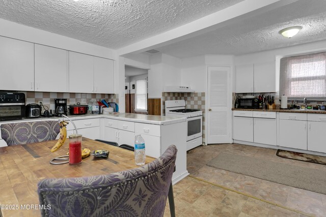 269 Port Monmouth Rd, North Middletown, NJ 07748 - kitchen featuring white gas range, a sink, a textured ceiling, decorative backsplash, and white cabinetry