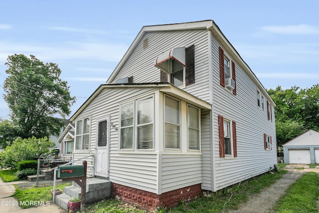 269 Port Monmouth Rd, North Middletown, NJ 07748 - view of side of home featuring a garage, an outdoor structure, and cooling unit