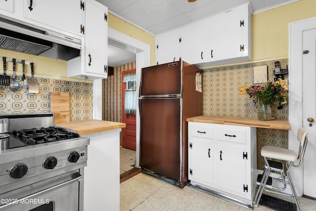 30 Balloch Pl, Red Bank, NJ 07701 - kitchen with stainless steel gas range oven, freestanding refrigerator, under cabinet range hood, wallpapered walls, and white cabinetry