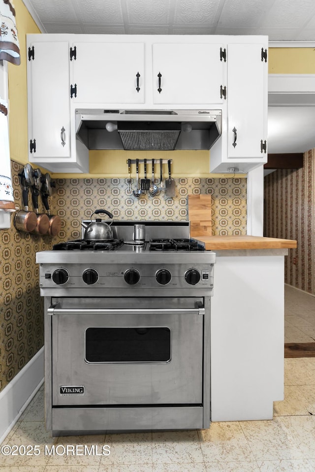 30 Balloch Pl, Red Bank, NJ 07701 - kitchen featuring designer stove, wallpapered walls, white cabinetry, exhaust hood, and light countertops