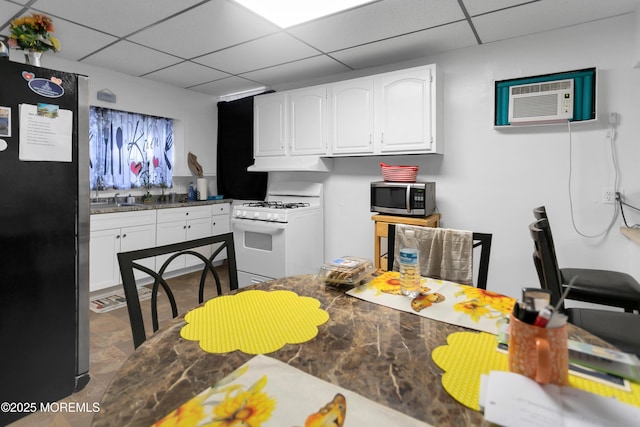 289 Port Monmouth Rd, North Middletown, NJ 07748 - kitchen featuring white gas stove, freestanding refrigerator, stainless steel microwave, a paneled ceiling, and white cabinetry