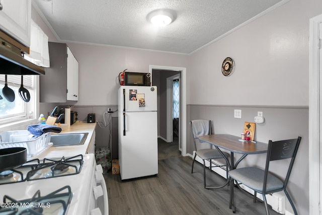 289 Port Monmouth Rd, North Middletown, NJ 07748 - kitchen featuring white appliances, a textured ceiling, dark wood finished floors, light countertops, and white cabinets