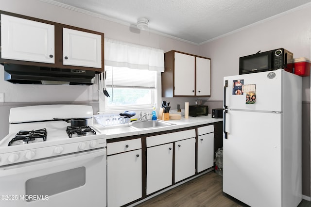 289 Port Monmouth Rd, North Middletown, NJ 07748 - kitchen featuring white appliances, under cabinet range hood, white cabinetry, light countertops, and a sink
