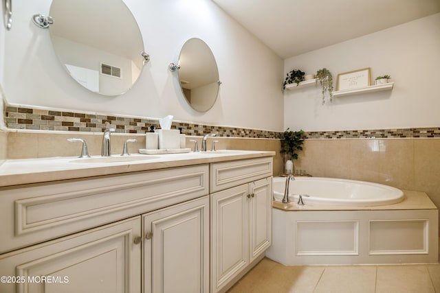 40 Dickerson Ln, Old Bridge, NJ 08857 - bathroom with double vanity, tile patterned floors, a garden tub, and tile walls