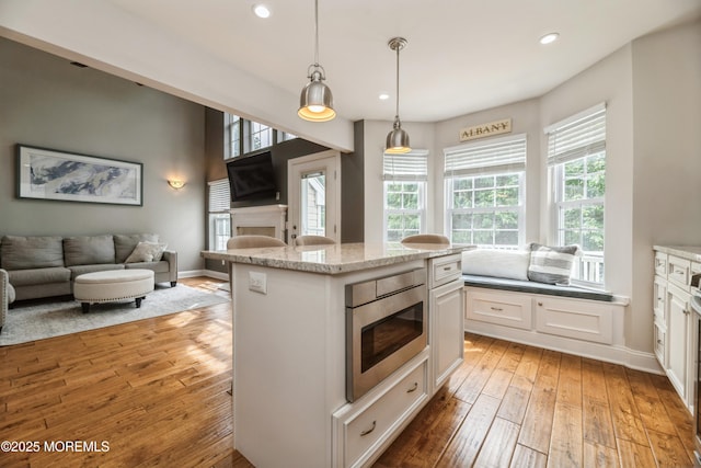 40 Dickerson Ln, Old Bridge, NJ 08857 - kitchen with light wood finished floors, stainless steel microwave, open floor plan, white cabinets, and recessed lighting