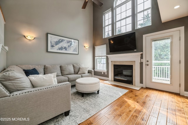 40 Dickerson Ln, Old Bridge, NJ 08857 - living room with hardwood / wood-style floors, ceiling fan, a fireplace with flush hearth, baseboards, and a towering ceiling