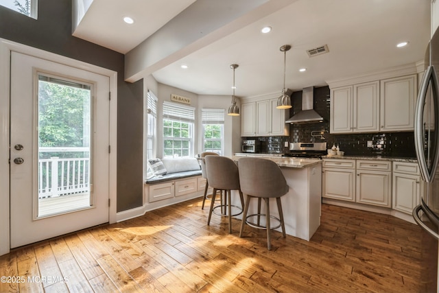 40 Dickerson Ln, Old Bridge, NJ 08857 - kitchen featuring wall chimney exhaust hood, stainless steel appliances, a center island, light wood-type flooring, and backsplash