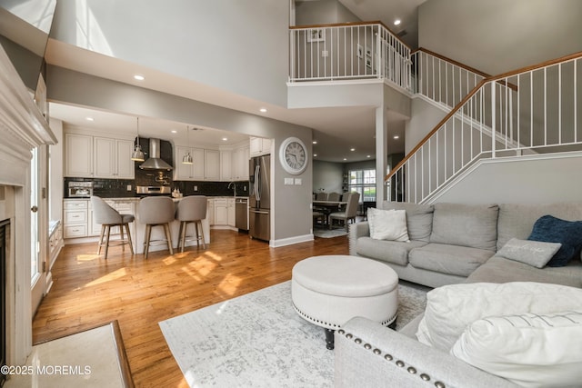 40 Dickerson Ln, Old Bridge, NJ 08857 - living area with a high ceiling, light wood-type flooring, stairs, recessed lighting, and baseboards