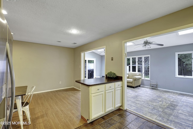 1299 E County Line Rd, Lakewood, NJ 08701 - kitchen with dark countertops, stainless steel fridge with ice dispenser, open floor plan, a textured ceiling, and baseboards